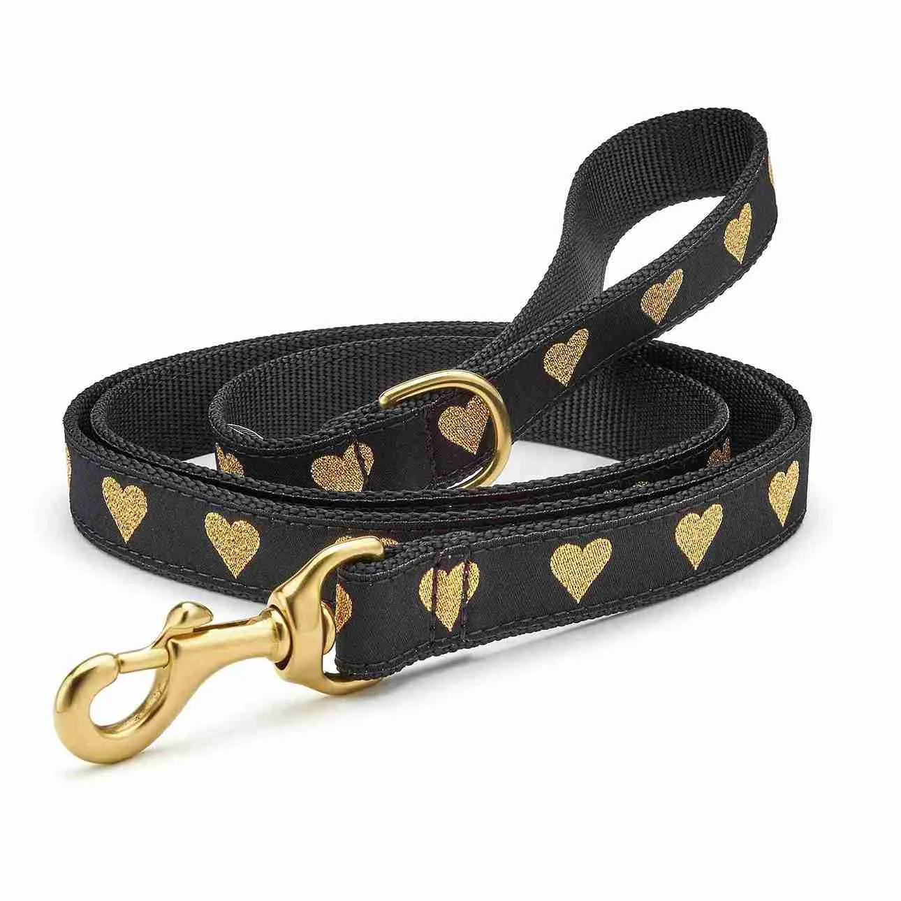 Close-up of black dog lead with golden heart pattern