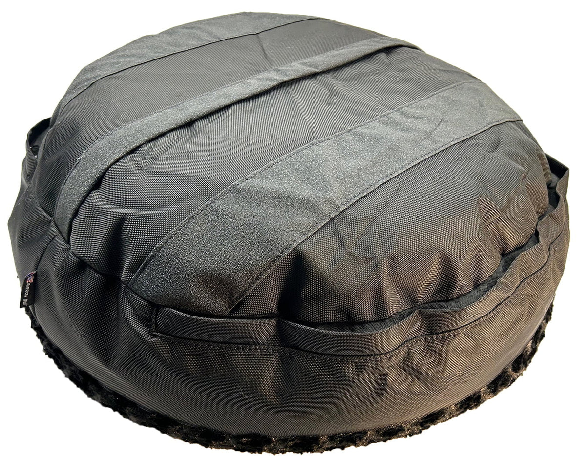 Underside of a black round dog bed showing sewn-in non-slip grip strips