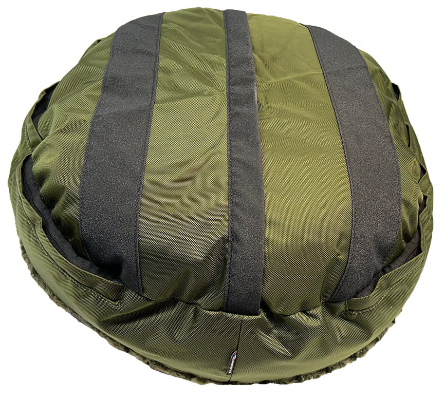 Underside of an olive round dog bed showing black non-slip grip strips