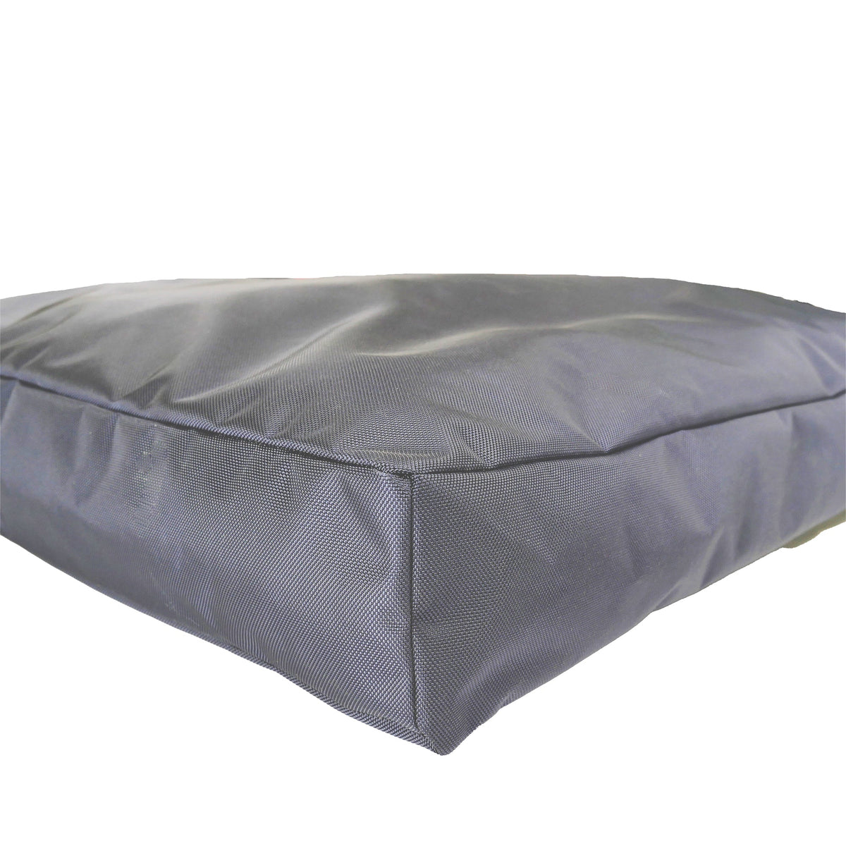 Corner close-up of a charcoal gray rectangular dog bed showing tough woven fabric