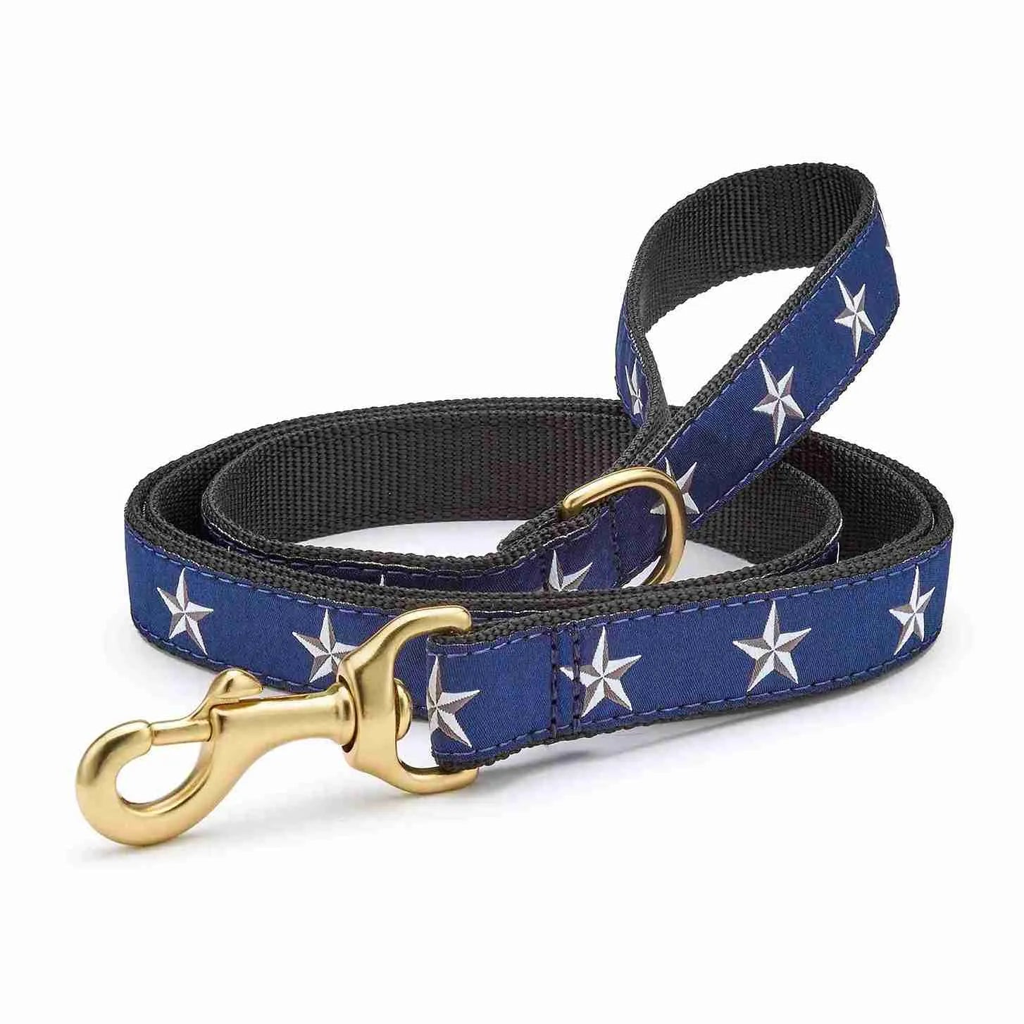 North Star Dog Lead with navy blue background, white stars, and brass hardware.