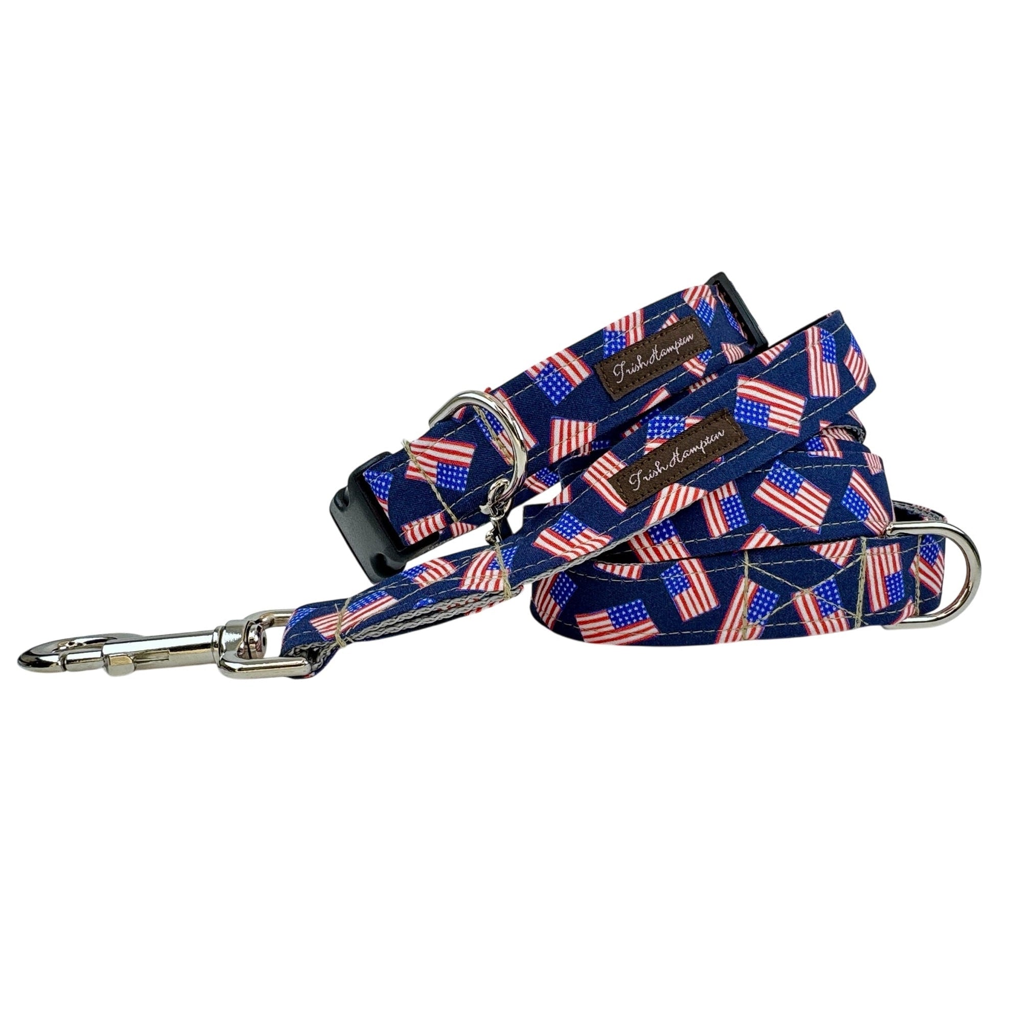 Coiled navy dog leash and matching collar with small American flag print and silver snap hook